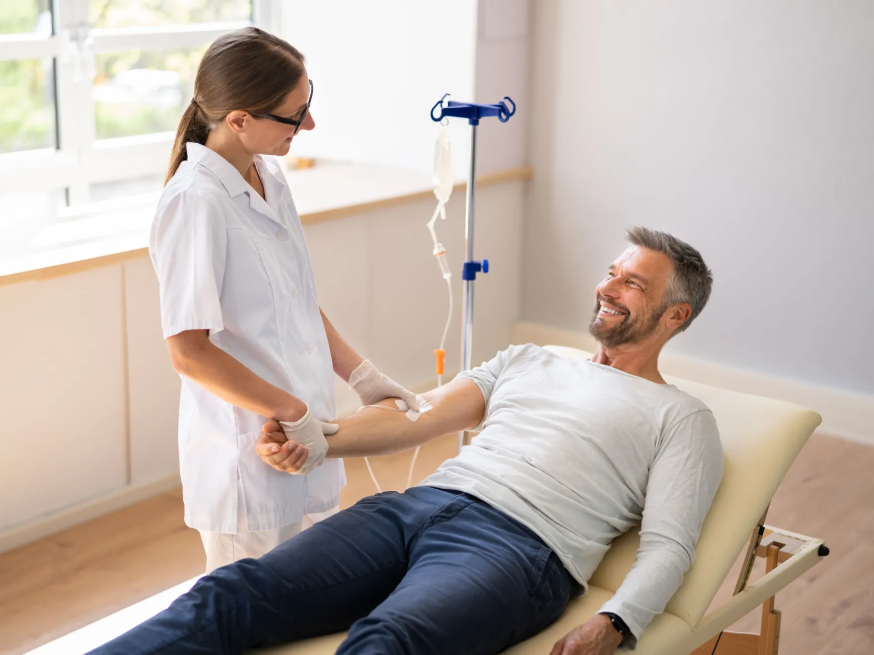 a man smiling while getting her teeth checked