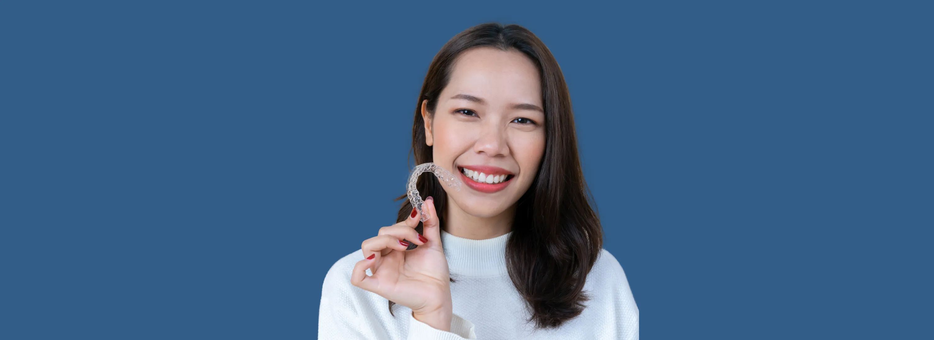 a woman holding a cell phone up to her face