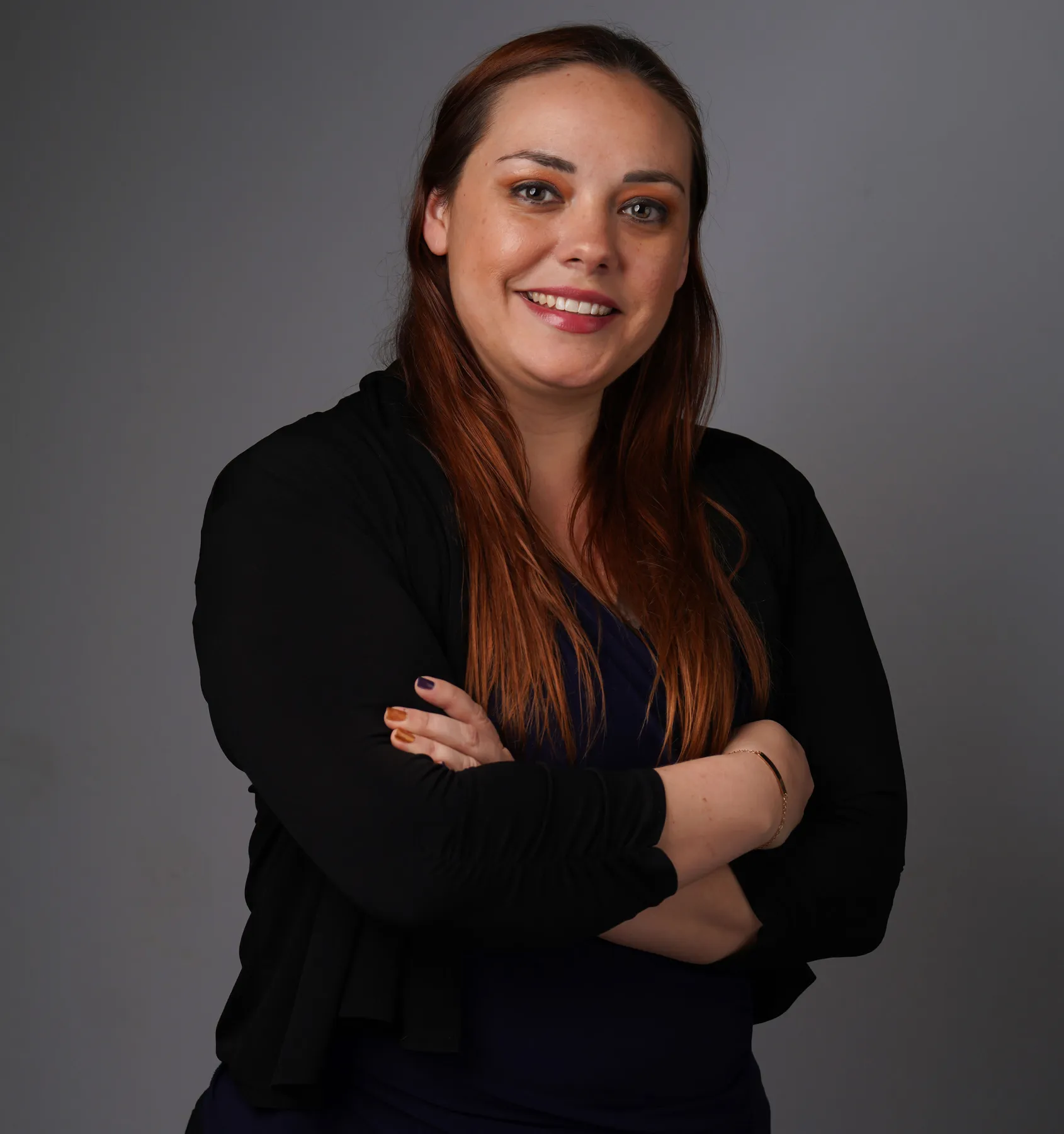 a woman posing for a picture with her arms crossed
