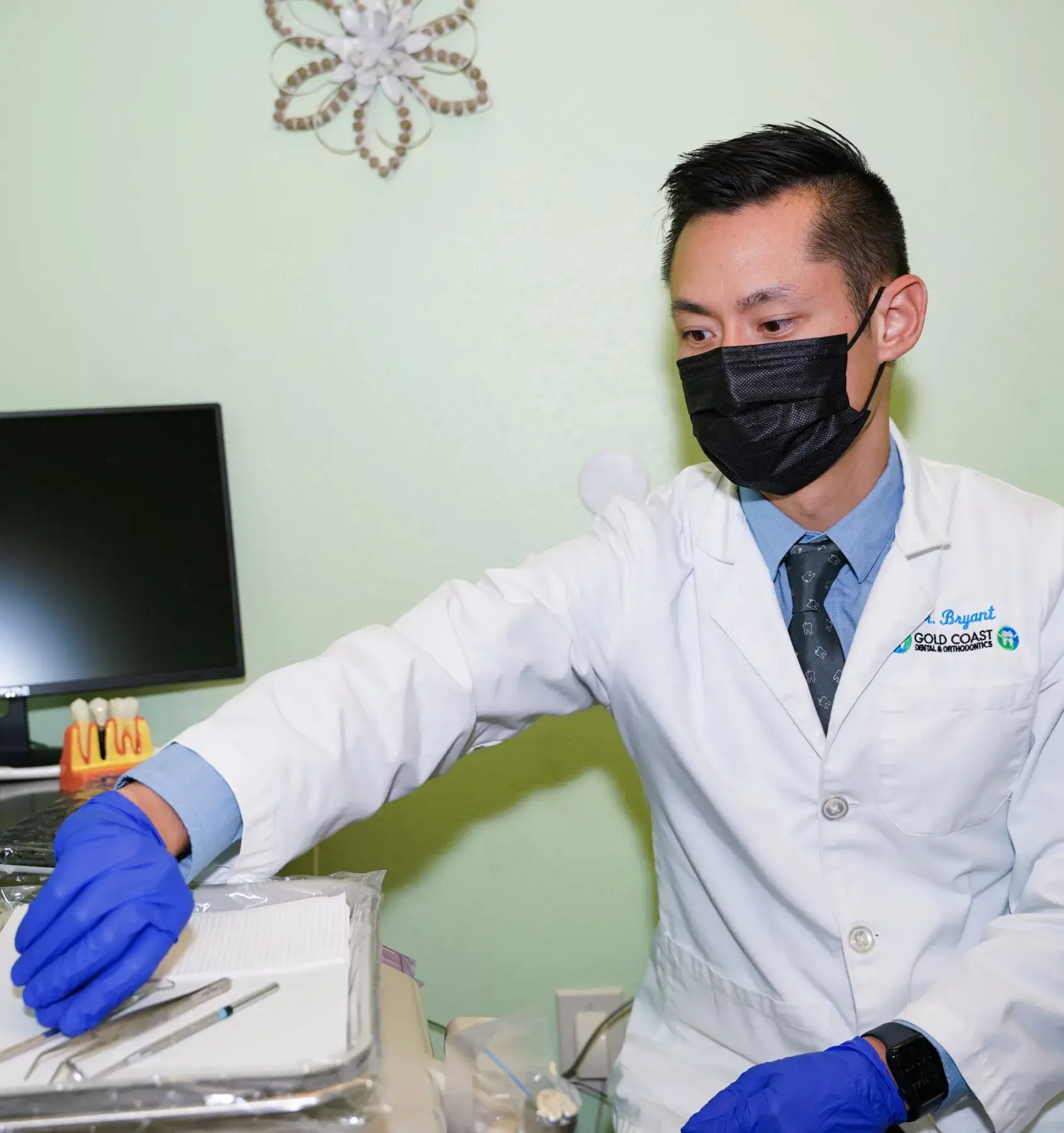 a man in a white lab coat and blue gloves
