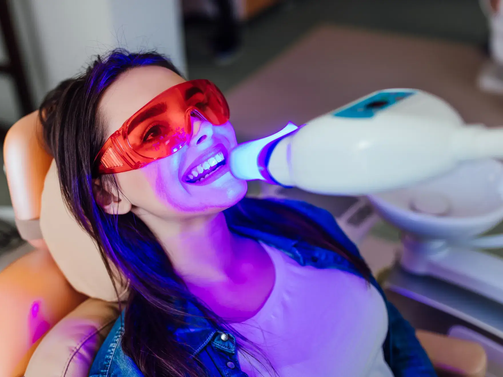 a woman wearing red glasses is brushing her teeth