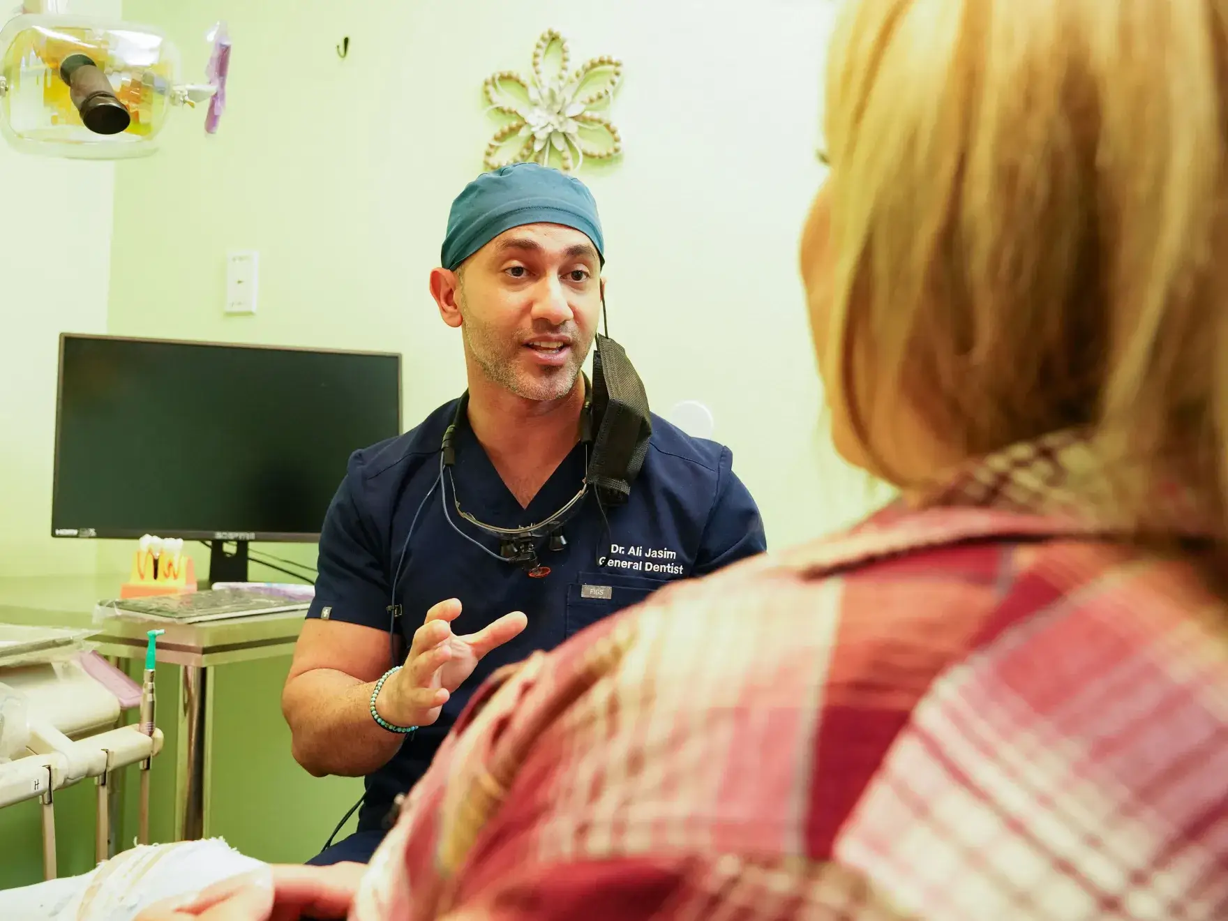 a man talking to a woman in a hospital room