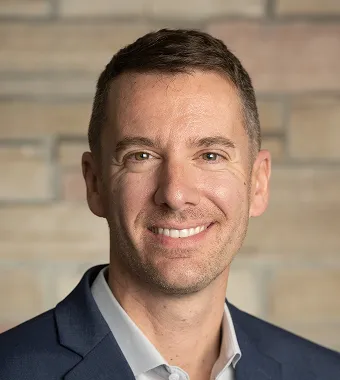 Dr. Augusto Miravalle, provider with extensive experience helping multiple sclerosis and neuroimmunology patients, smiling headshot