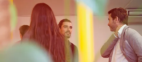 Three people talking to each other with light effects in the foreground