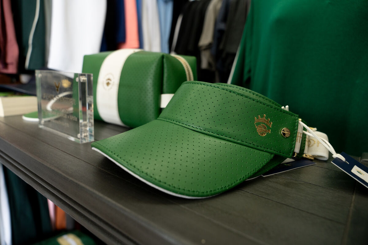 A close up of a visor hat with Coronado Tennis's logo.