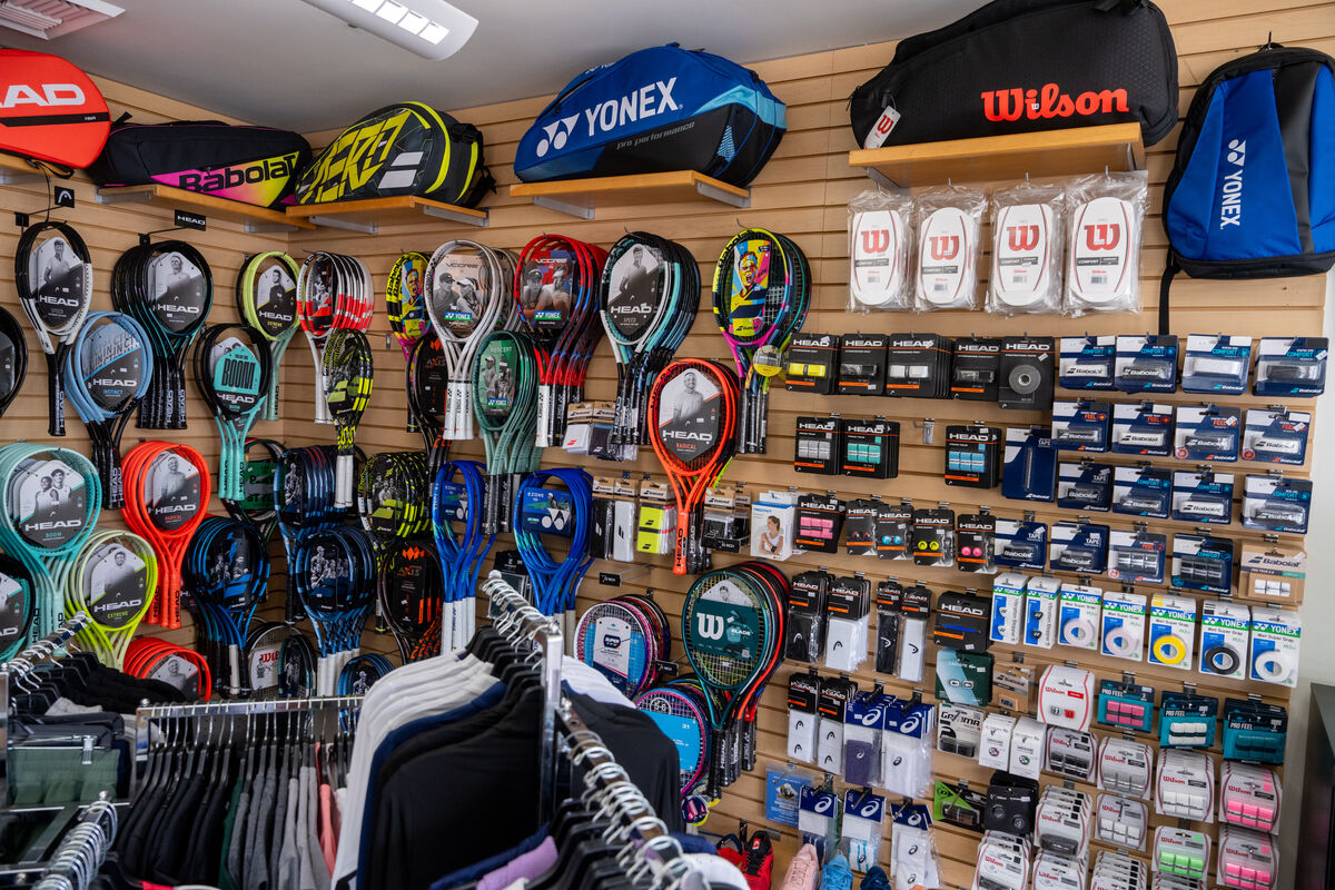 The interior of Coronado Tennis's store. Multiple items related to sports can be seen, such as paddles, raquets, balls, etc.