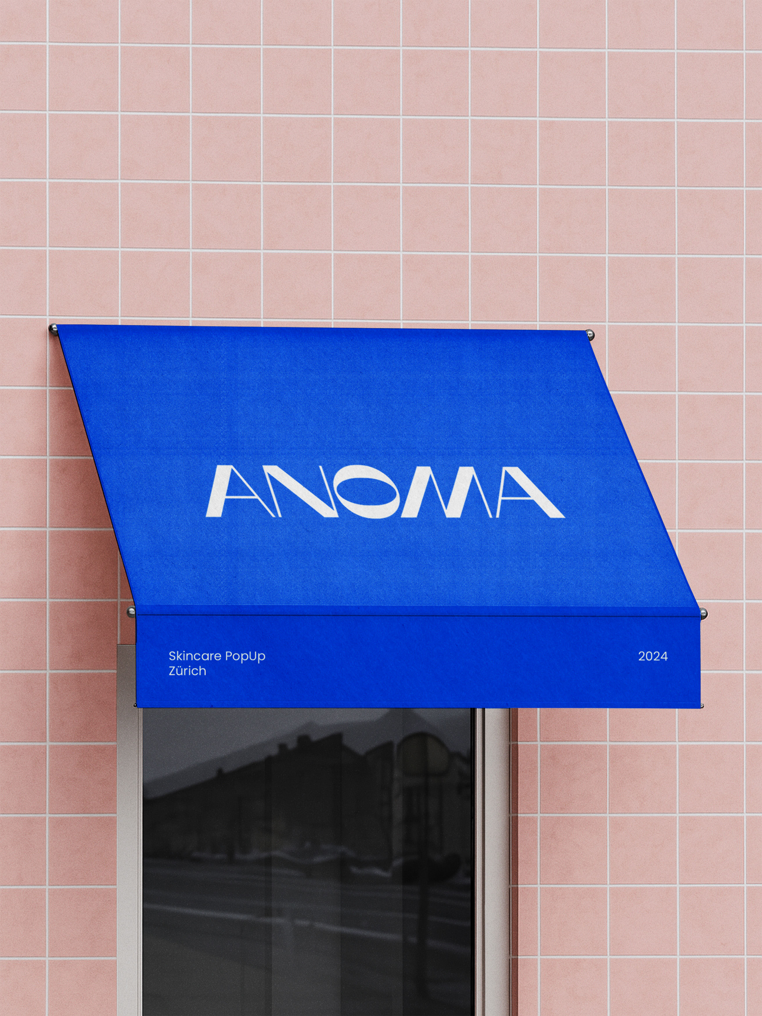 Campaign branding applied to a storefront awning for the ANOMA Pop-Up Zurich.