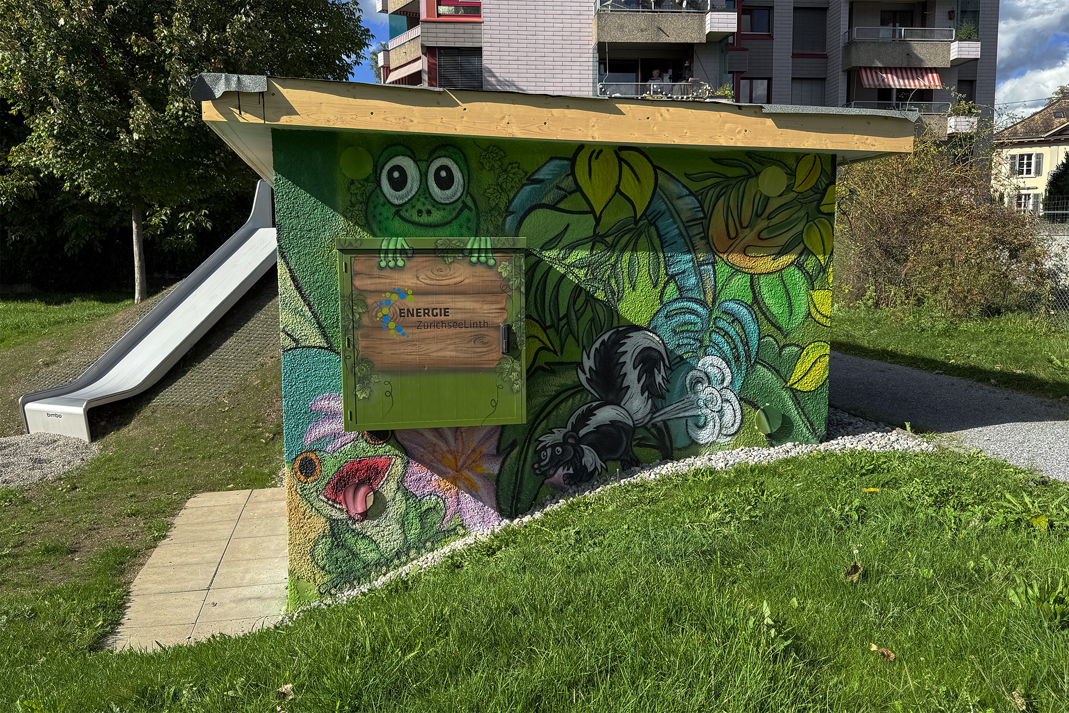 Character graffiti with frog, skunk and tropical plants; saturated colors designed for a family-friendly space.