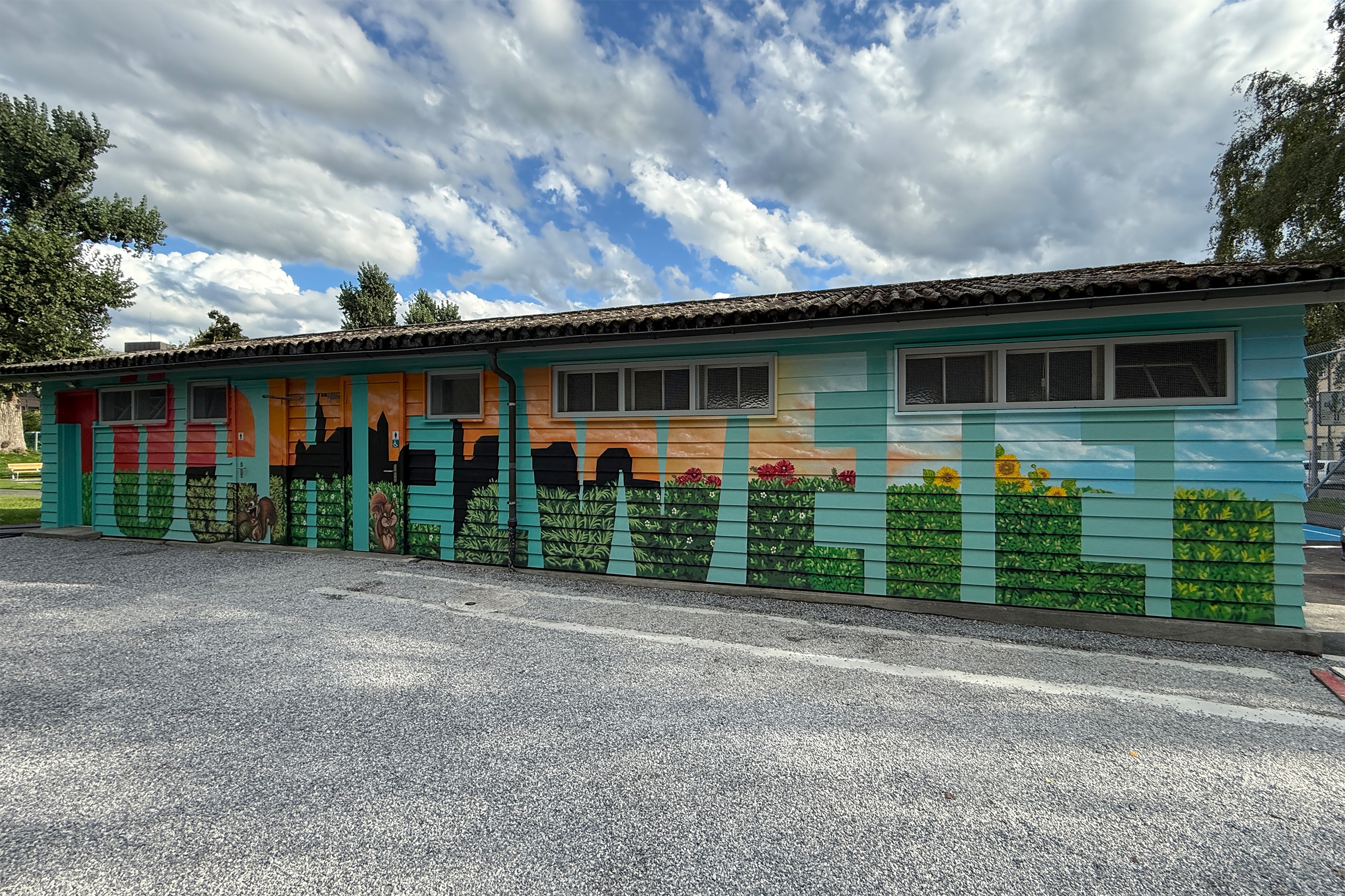 Extended side elevation blending city silhouette, sky gradients and trimmed hedges with flowers; continuous typographic rhythm across doors and windows.