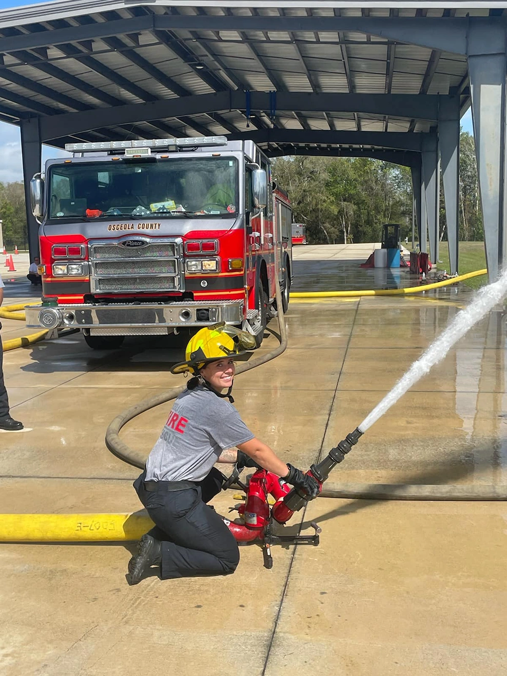 an Osceola fire fighter spraying a fire hose