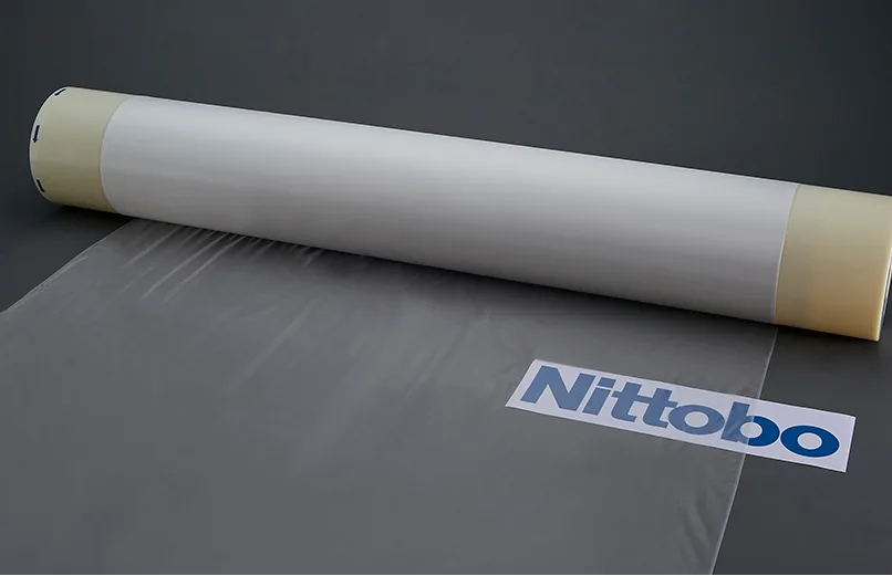 Roll of woven fiberglass cloth used as the structural reinforcement in PCB laminates, showing the regular grid pattern of glass yarn bundles.
