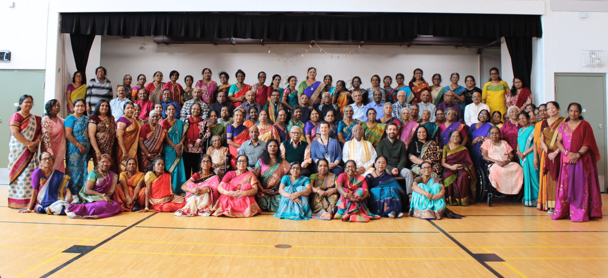 Two smiling children in green shirts, with a logo, stand against a yellow background. Text reads "Literacy in Action: A Back-to-School Resource for Families and Educators."
