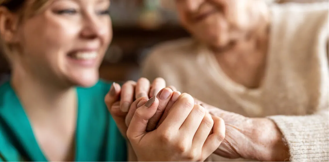 caregiver holding hands with patient