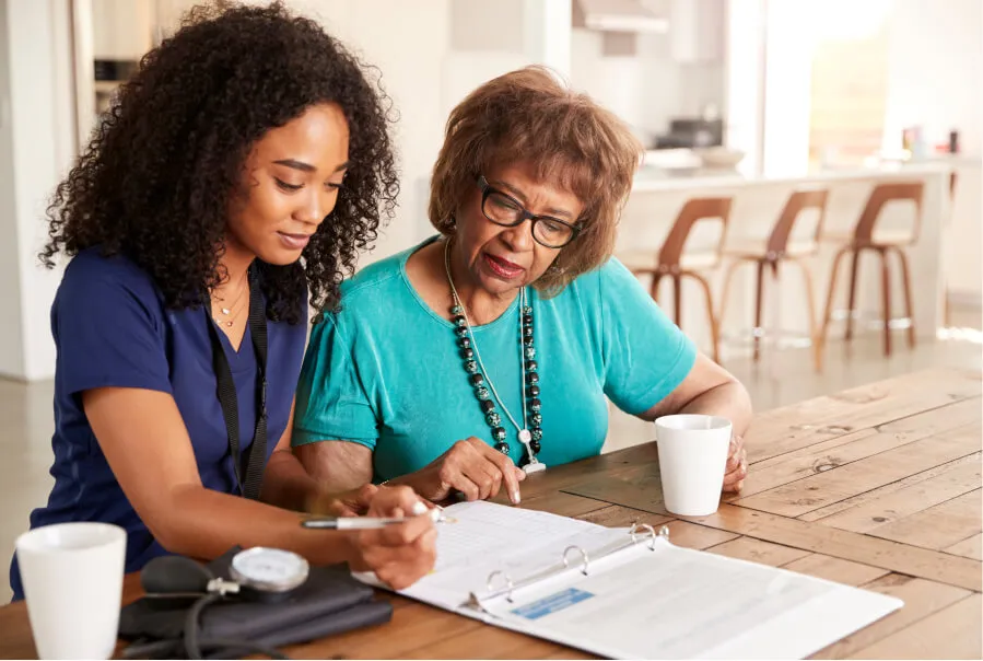 Caregiver helping patient with paperwork