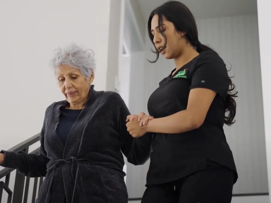 Era Life Care worker helping patient in home.