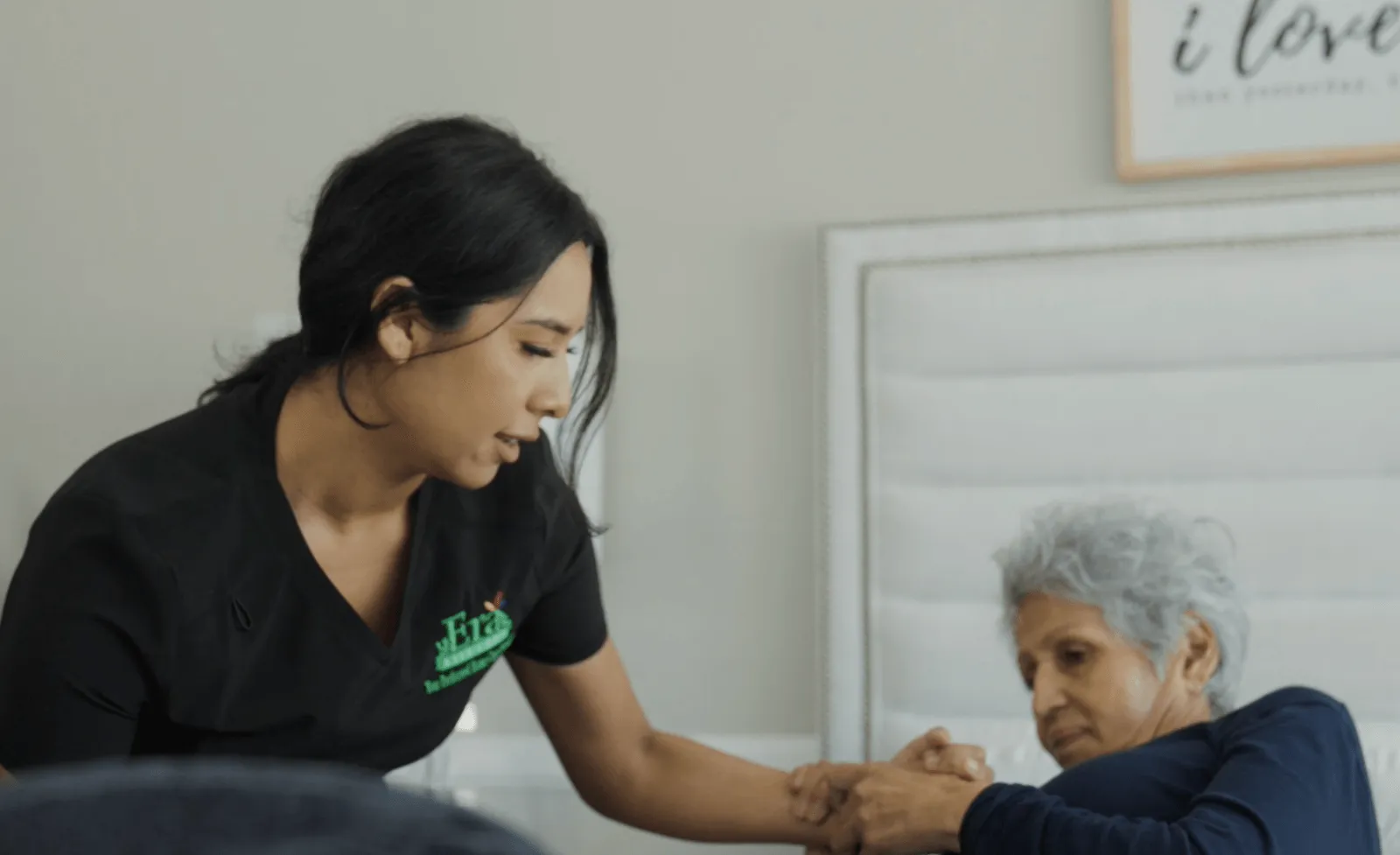 Caregiver helping patient out of bed