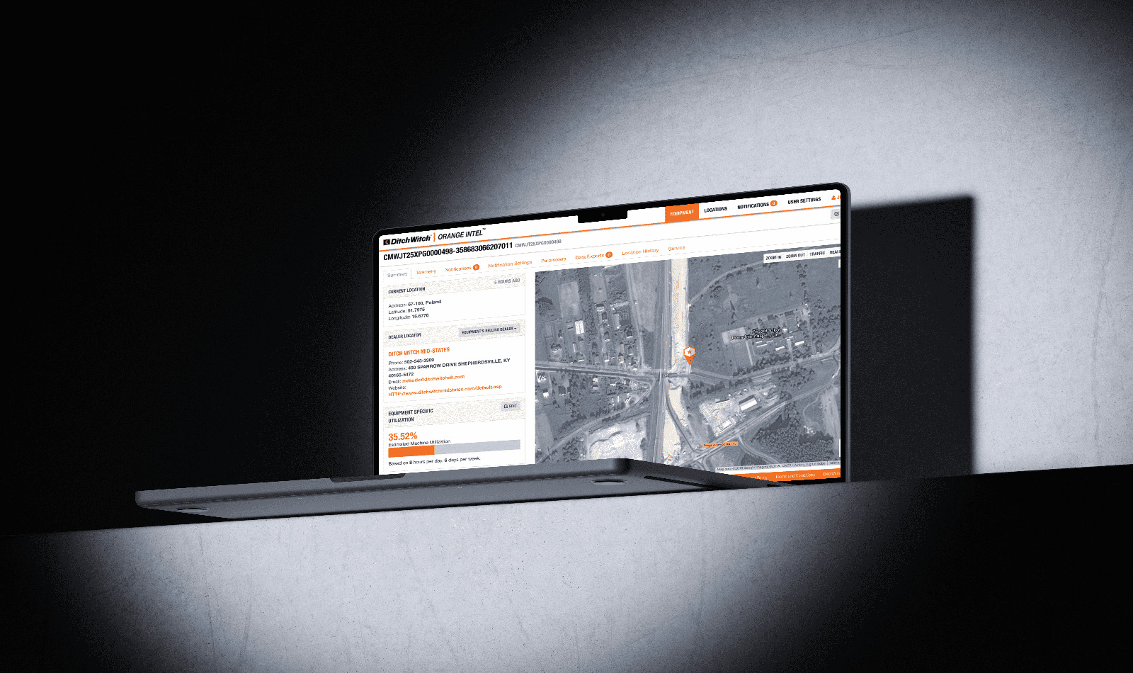 Laptop displaying Ditch Witch Orange Intel web interface with aerial map and equipment status information