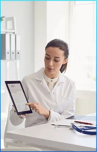 A healthcare professional in a white coat holds a digital tablet displaying a prescription in a bright, modern office setting.