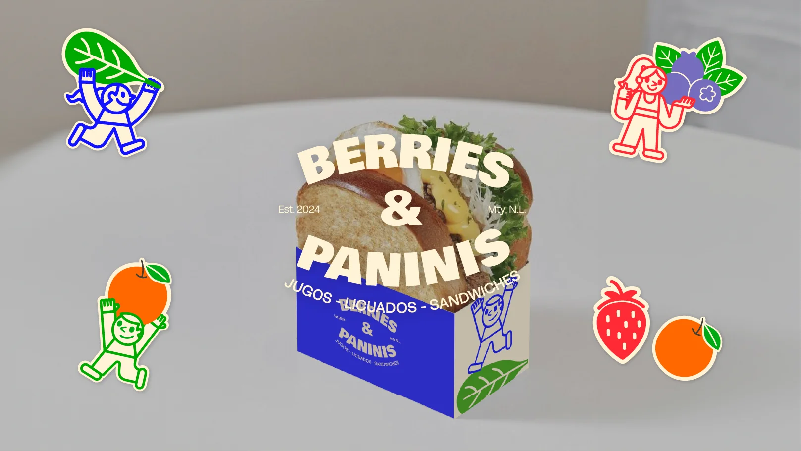 Sandwich in a blue and white branded box labeled 'Berries & Paninis' surrounded by colorful cartoon fruit and character stickers.