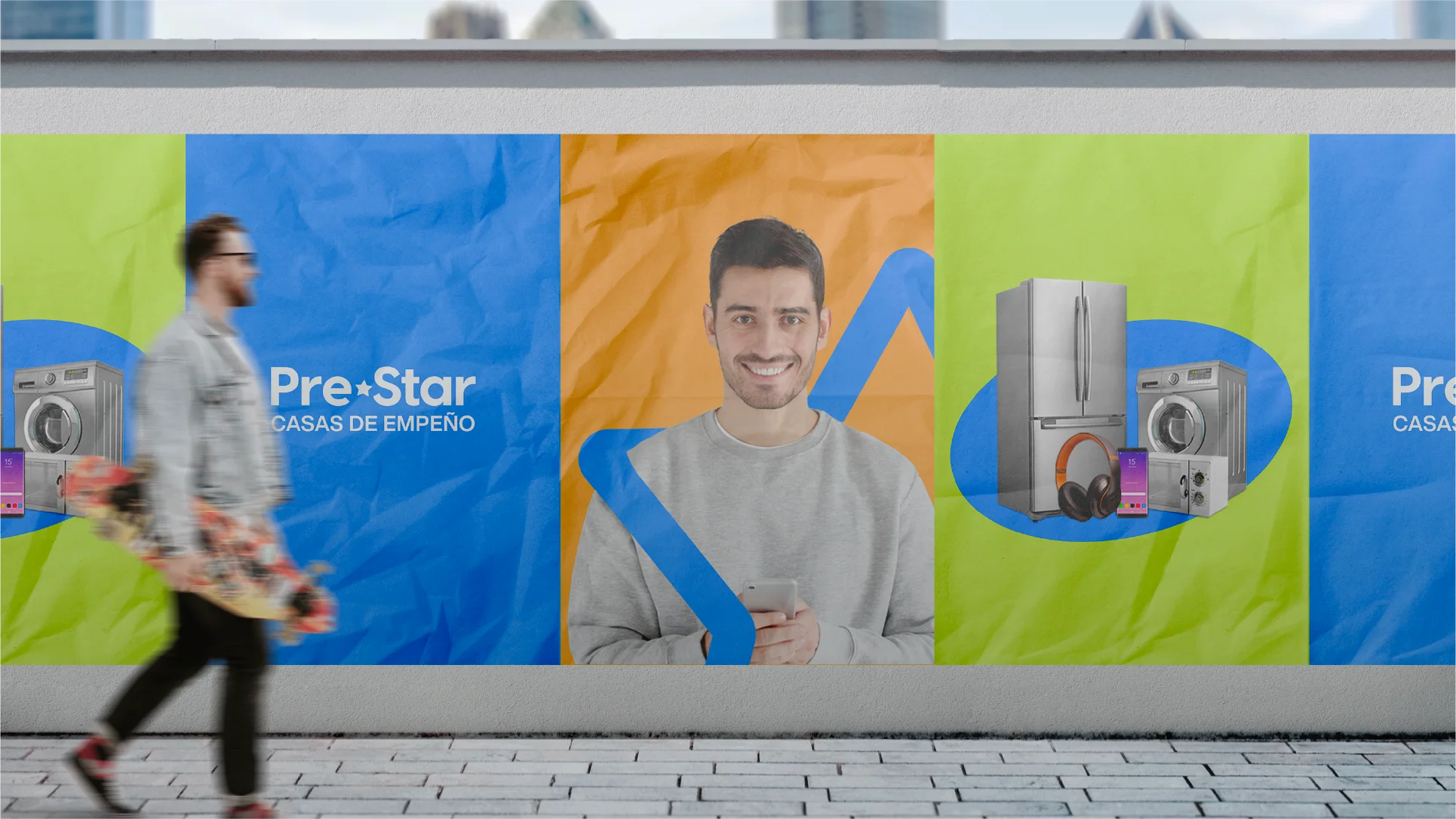 Outdoor advertisement with a smiling man holding a phone, surrounded by images of appliances and electronics on colorful panels, a blurred man carrying a skateboard walks by.