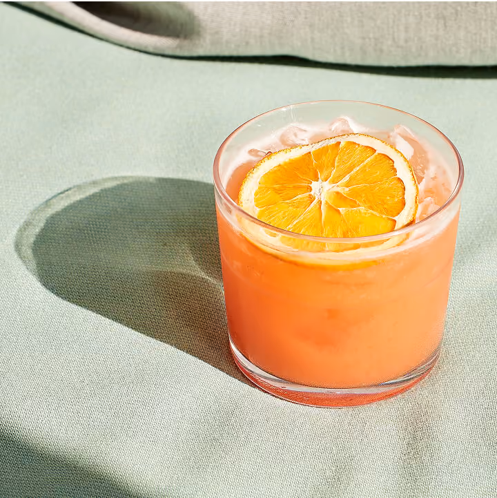 orange mixed drink on table top