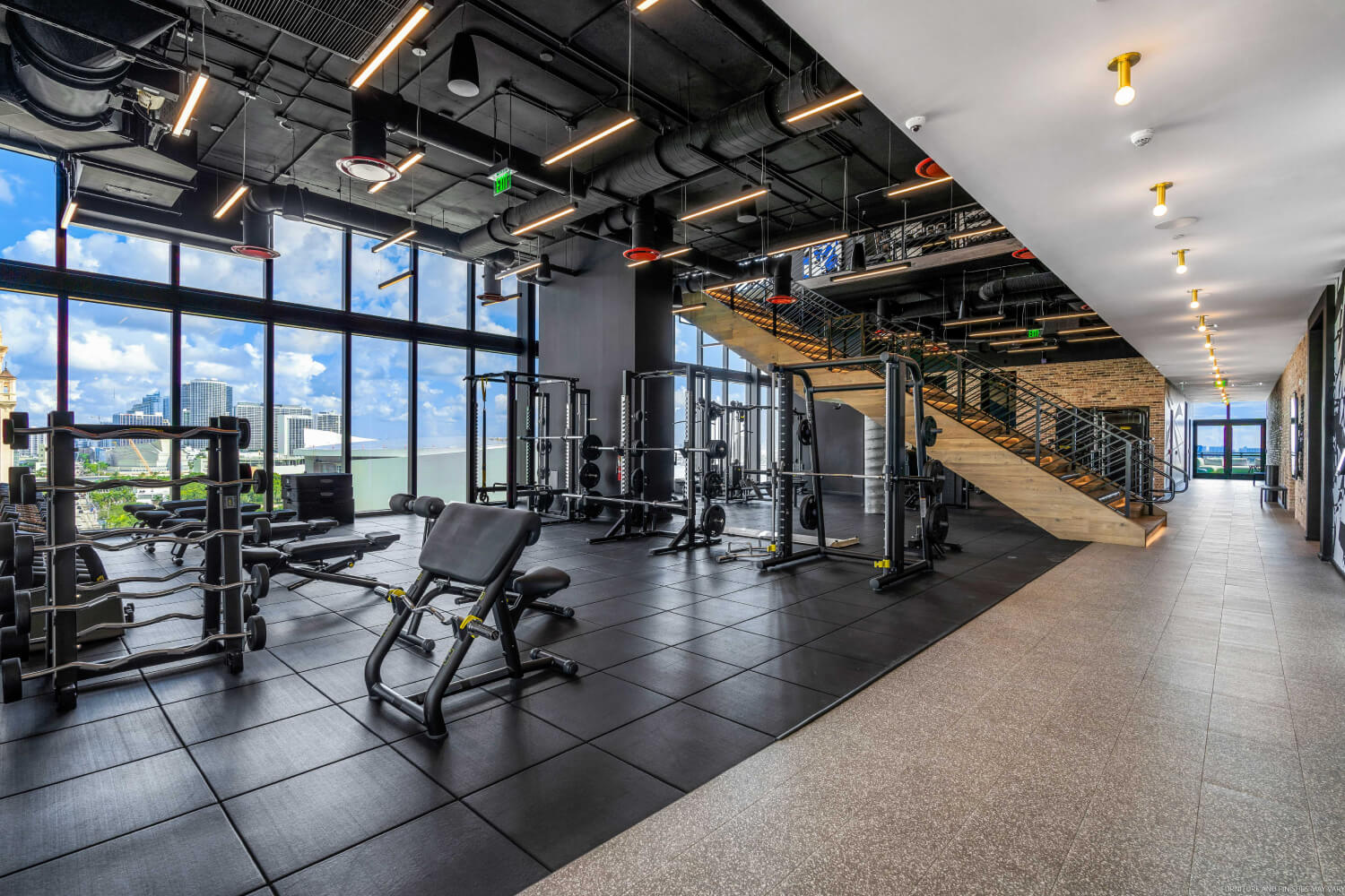 workout area of gym with view of miami