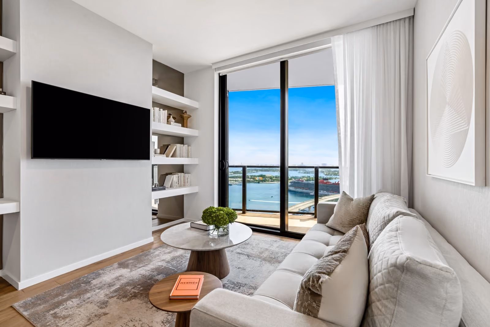 Living room of the Elser Hotel with tv and window view of miami