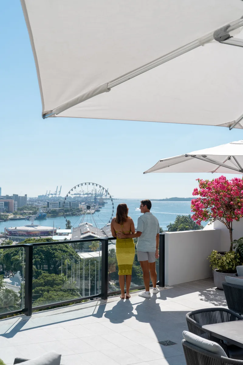 couple overlooking miami from rooftop terrace