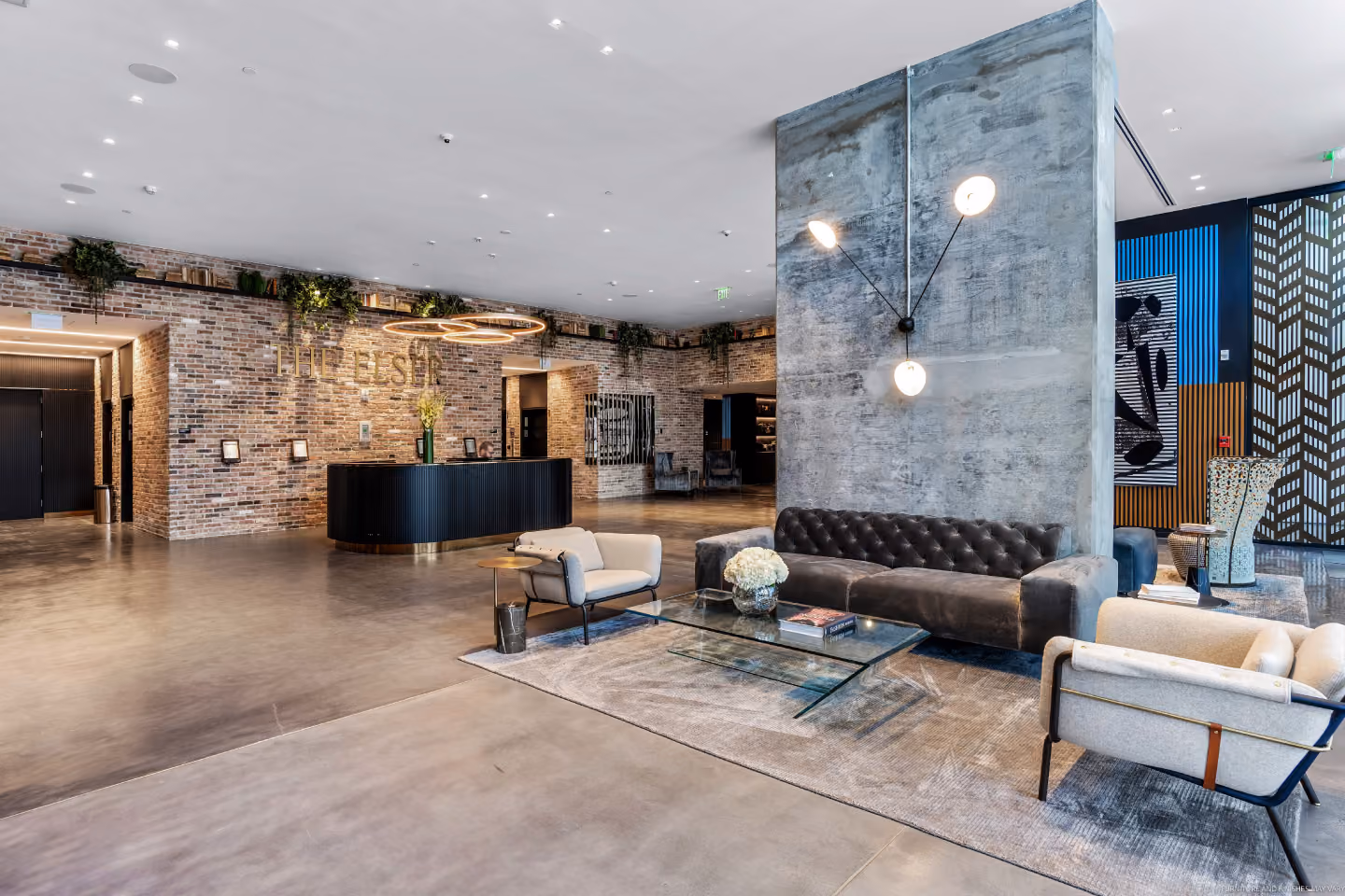 large lobby of the Elser hotel with lounge seating and check in front desk