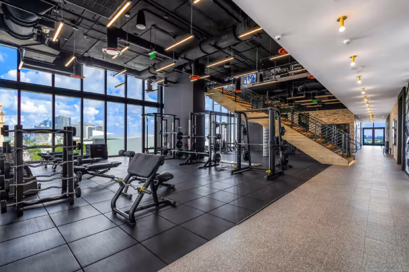 huge hotel gym with modern equipment, miami views and staircase to second level