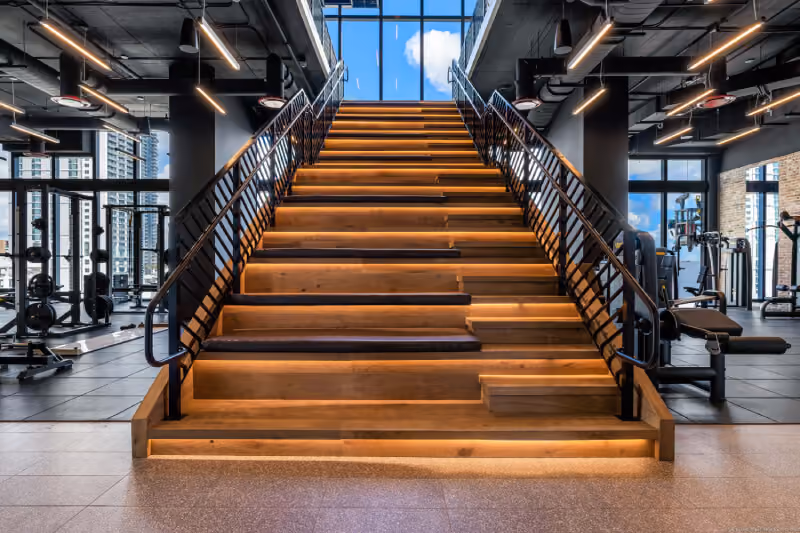 led lit gym stairs leading to second floor with window views