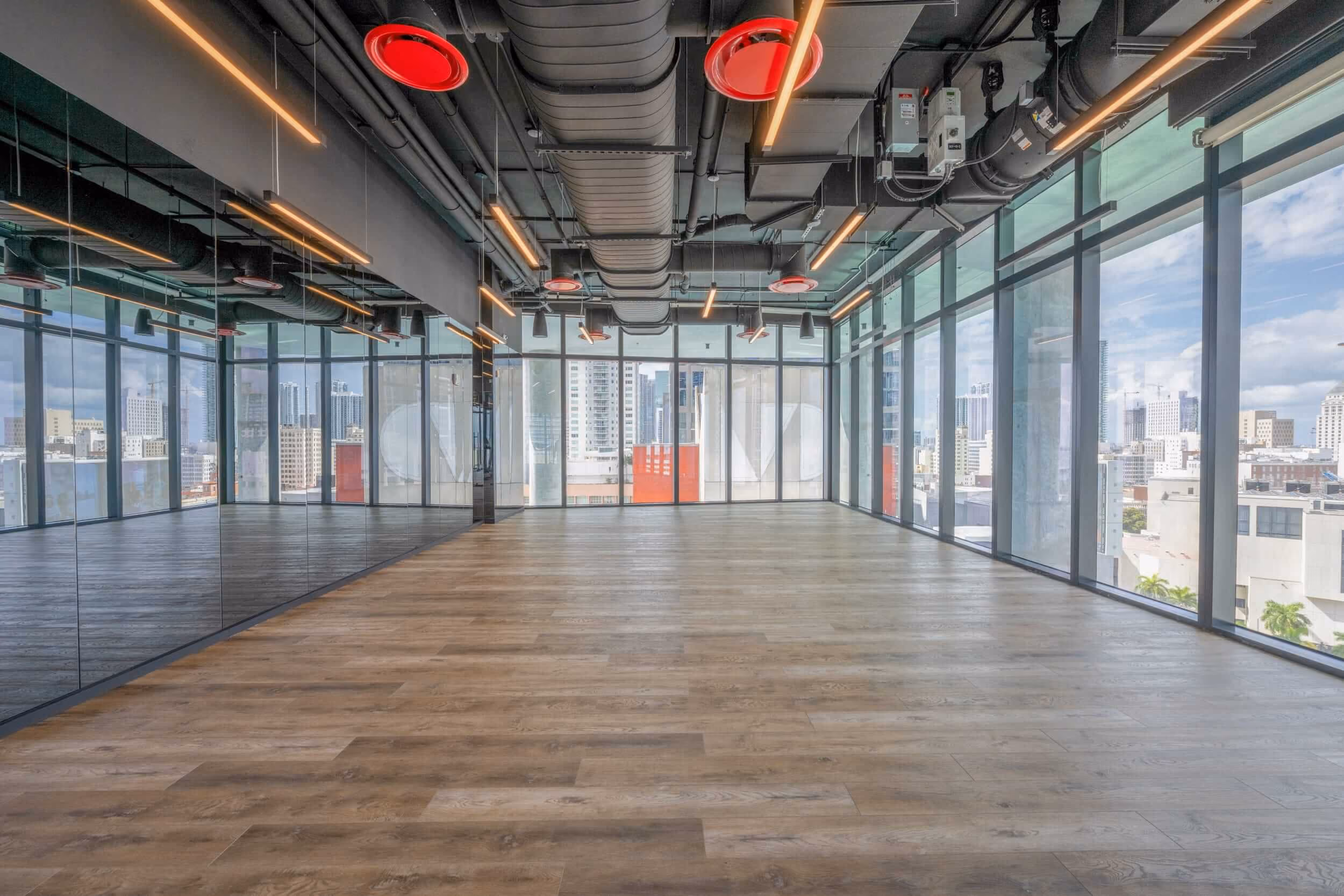 expansive fitness stuido with floor to ceiling windows overlooking miami