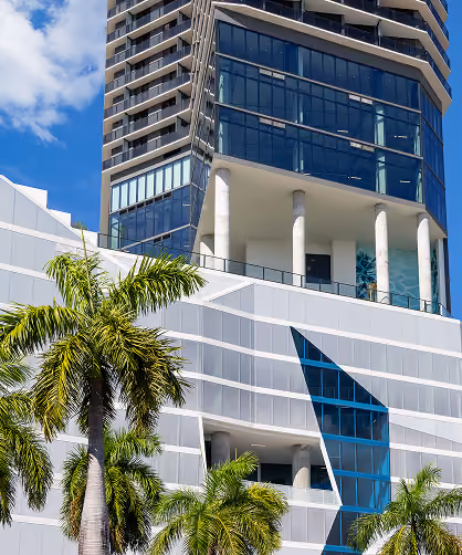 exterior of the elser hotel with palm trees
