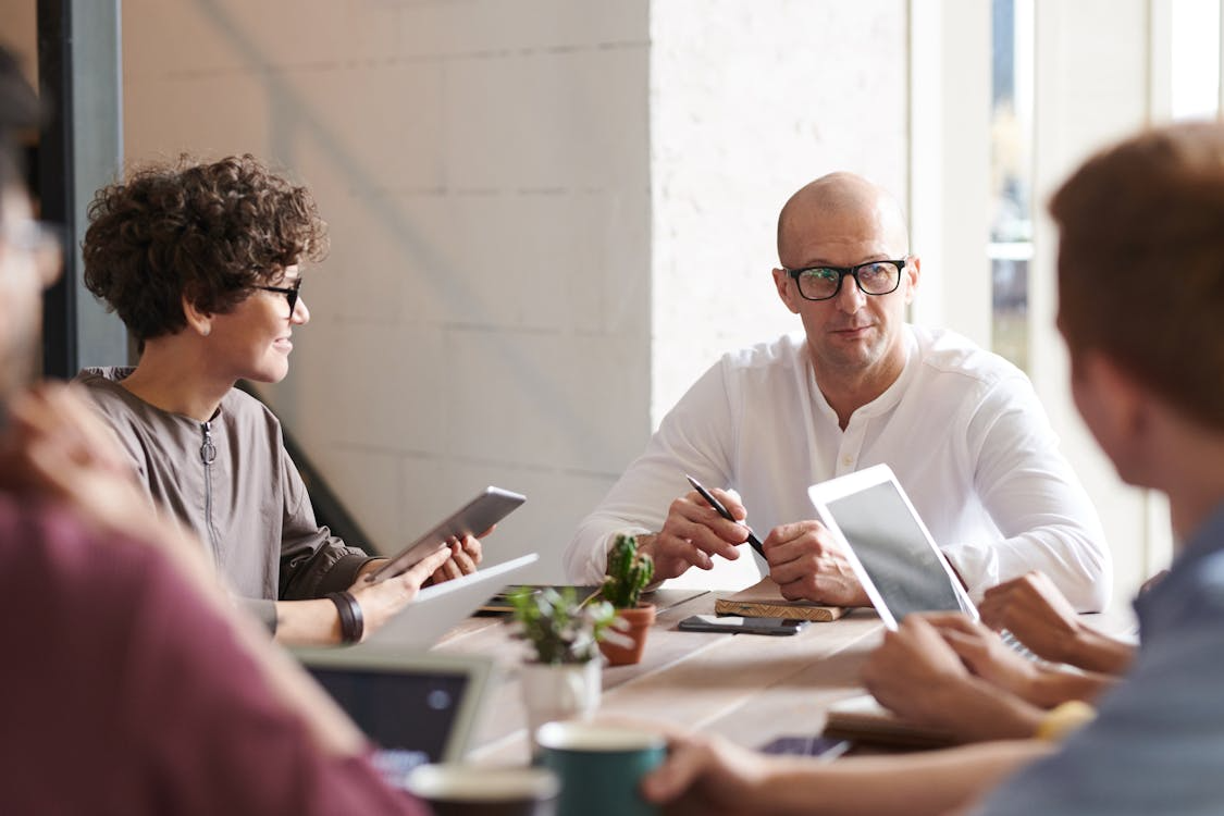 Man Sitting in Front of People