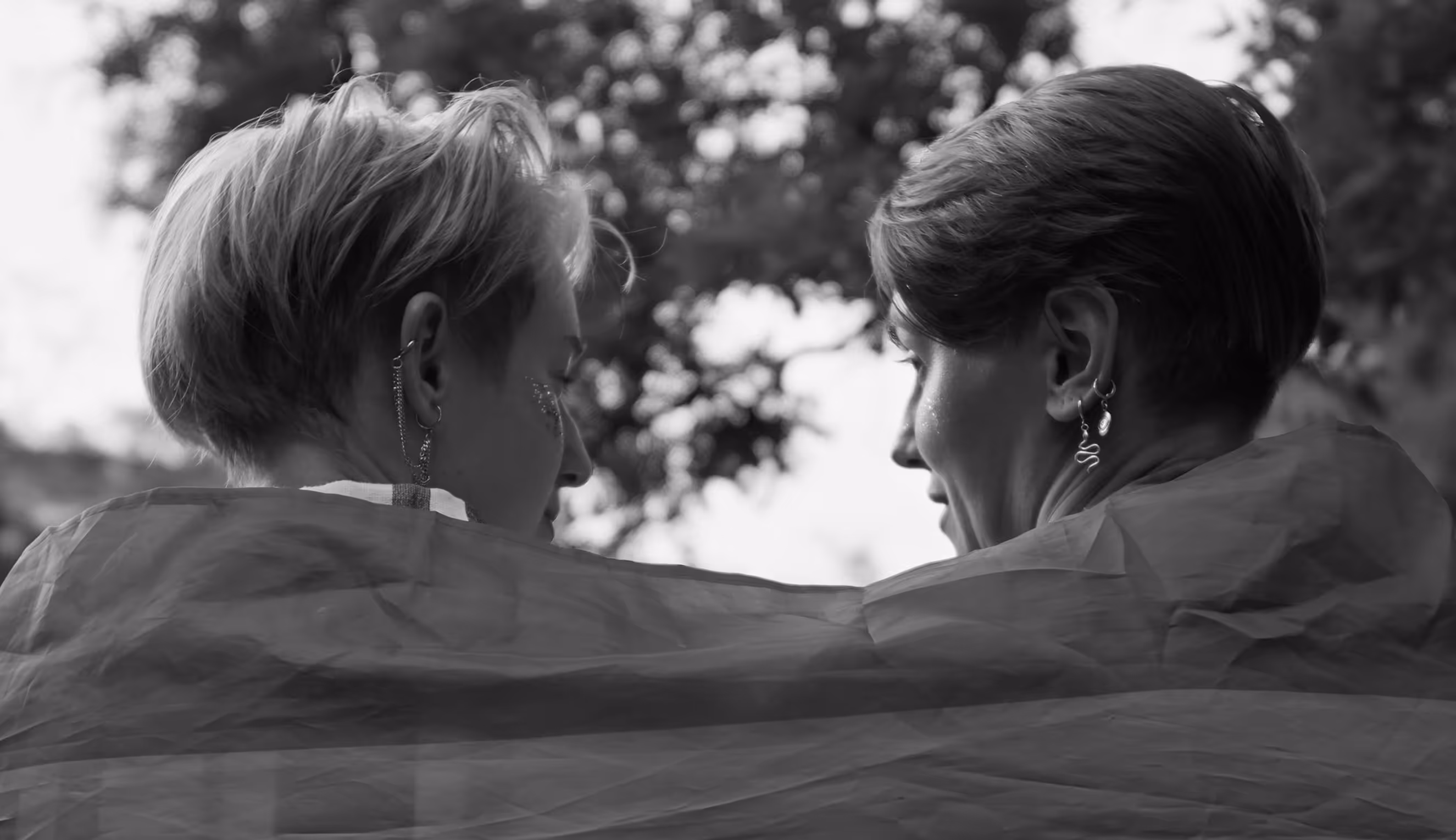 Two Adults Wrapped in an LGBTQ Pride Flag