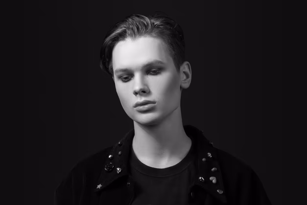 A person with makeup on in front of a black background