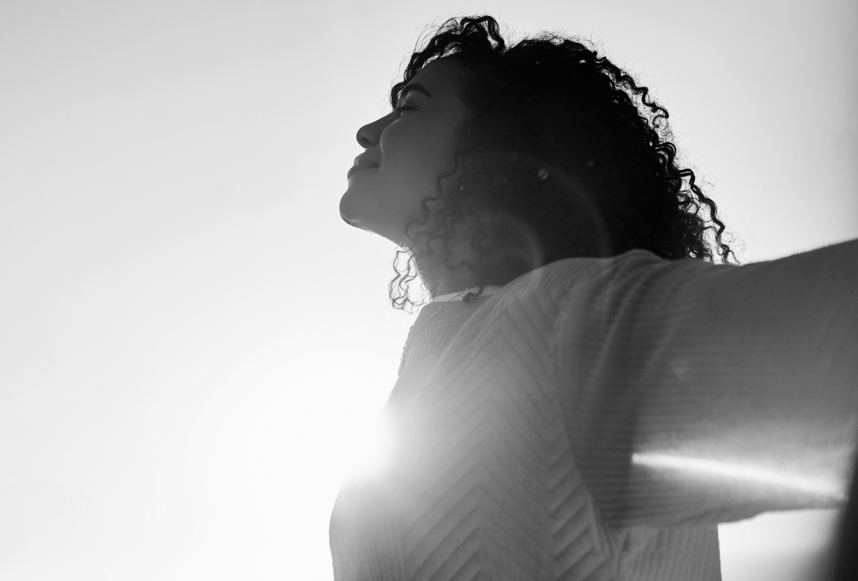 Carefree young person feeling relaxed outside in the morning light