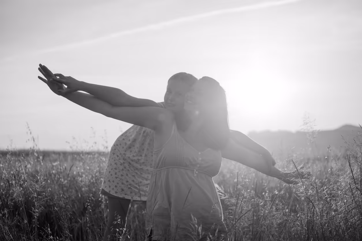 Two generations of women having fun outdoors in the sunlight