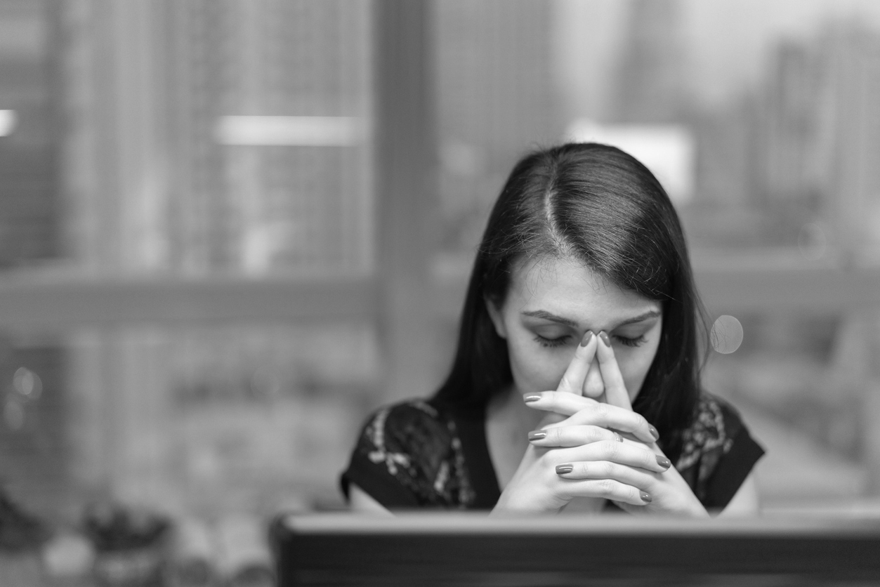 Burnt out LGBTQ college student looks at laptop screen