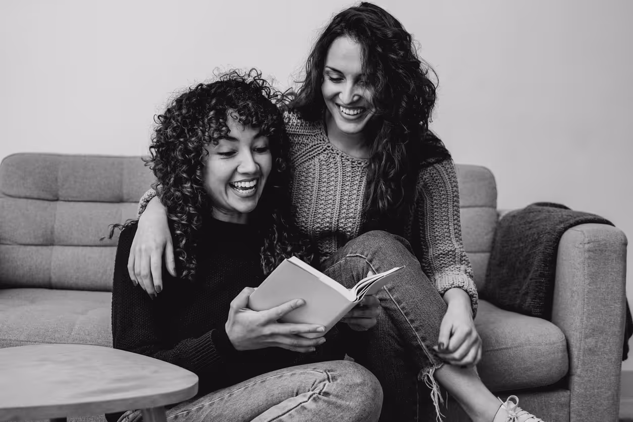 A lesbian couple reading a book