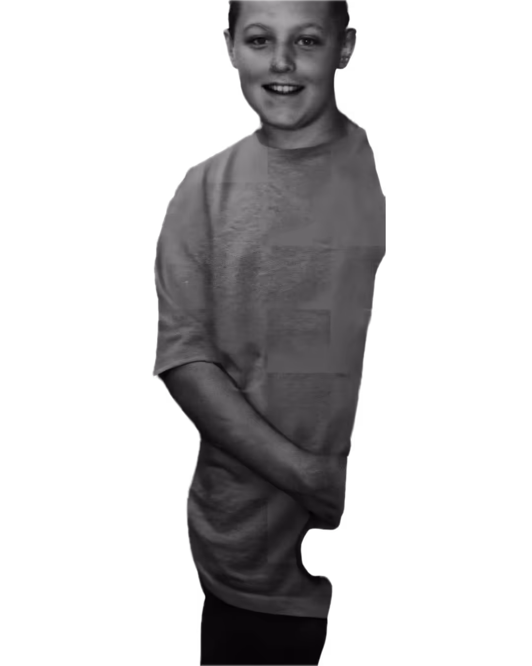 Smiling young person wearing a casual T-shirt, with hands clasped in front.
