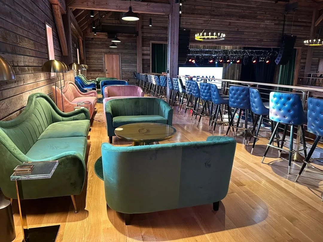 View of suite from rear, including couches, table and stage-view barstools