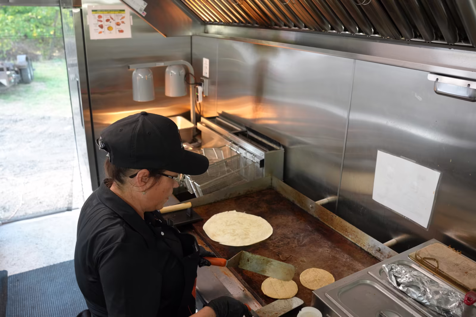 Kitchen La Familia cook at Summer Farewell Fest event hosted by Kitchen La Familia, Grand Rapids Premiere Mexican Caterer