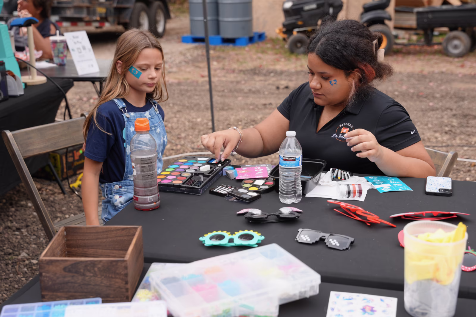 Face paint vendor at Summer Farewell Fest event hosted by Kitchen La Familia, Grand Rapids Premiere Mexican Caterer