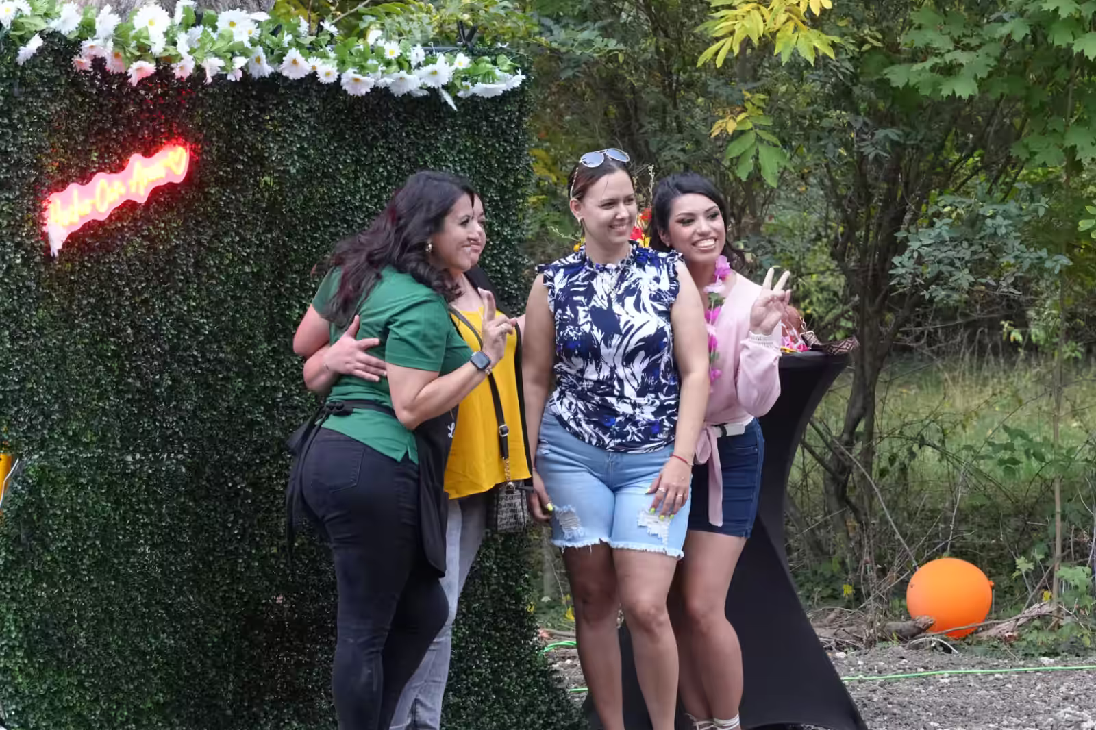 Group using selfie wall at Summer Farewell Fest event hosted by Kitchen La Familia, Grand Rapids Premiere Mexican Caterer
