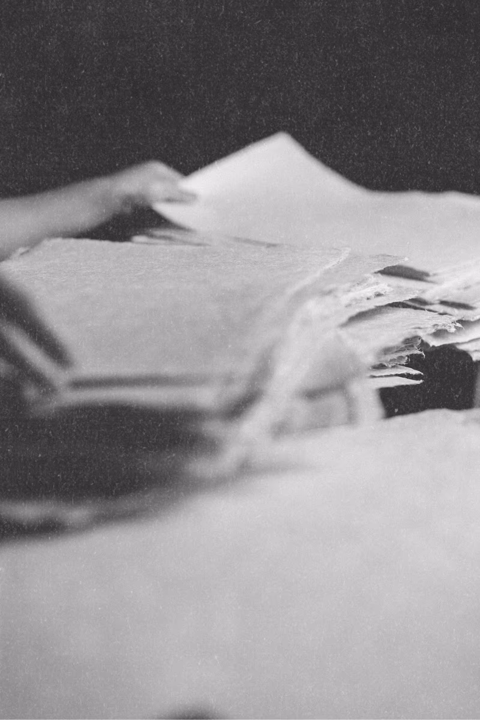 Close-up of hand-crafted journal pages showing the hand selection of natural fibers and subtle texture