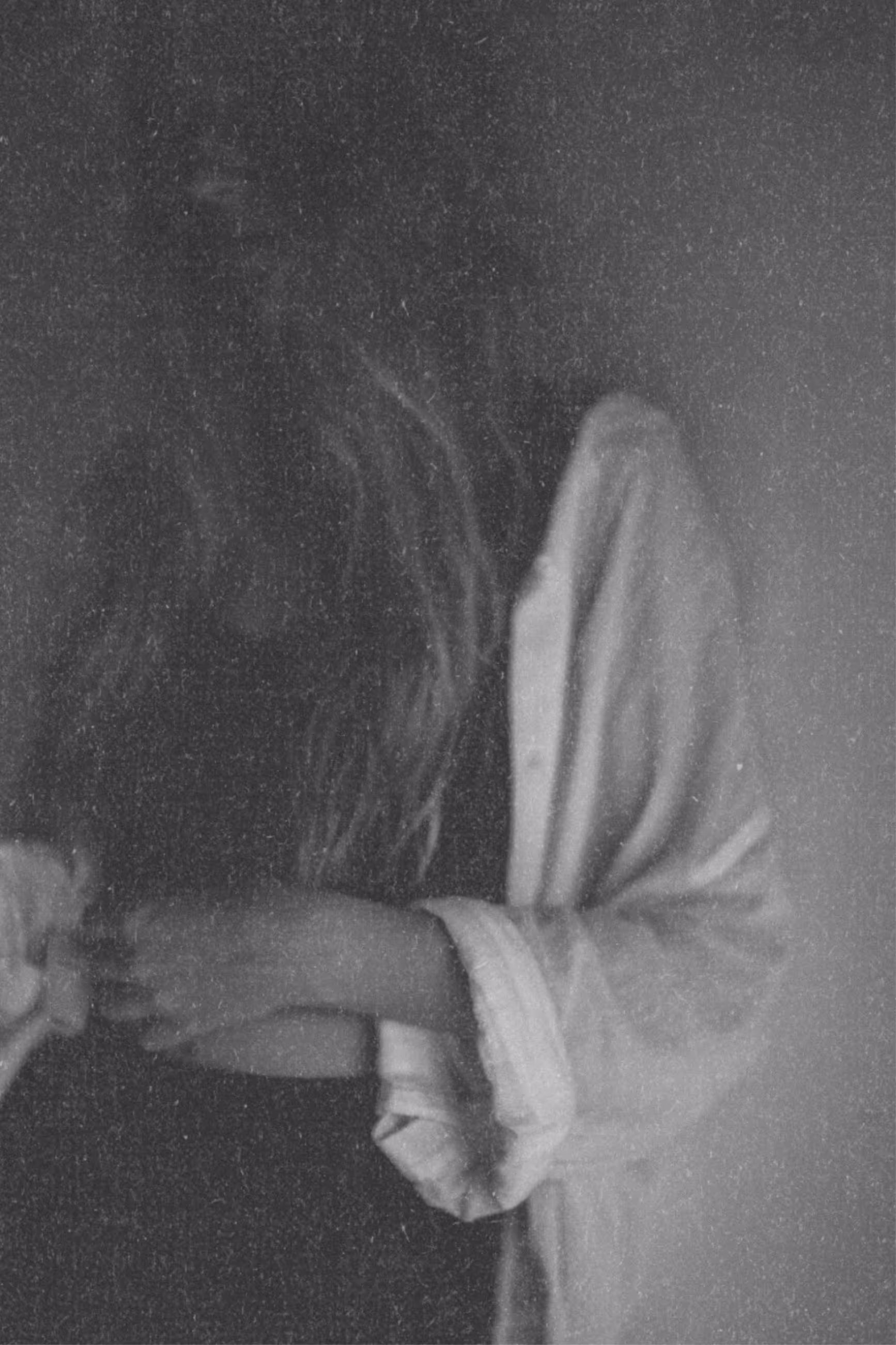 Mysterious black and white artist portrait with fine art paper texture.