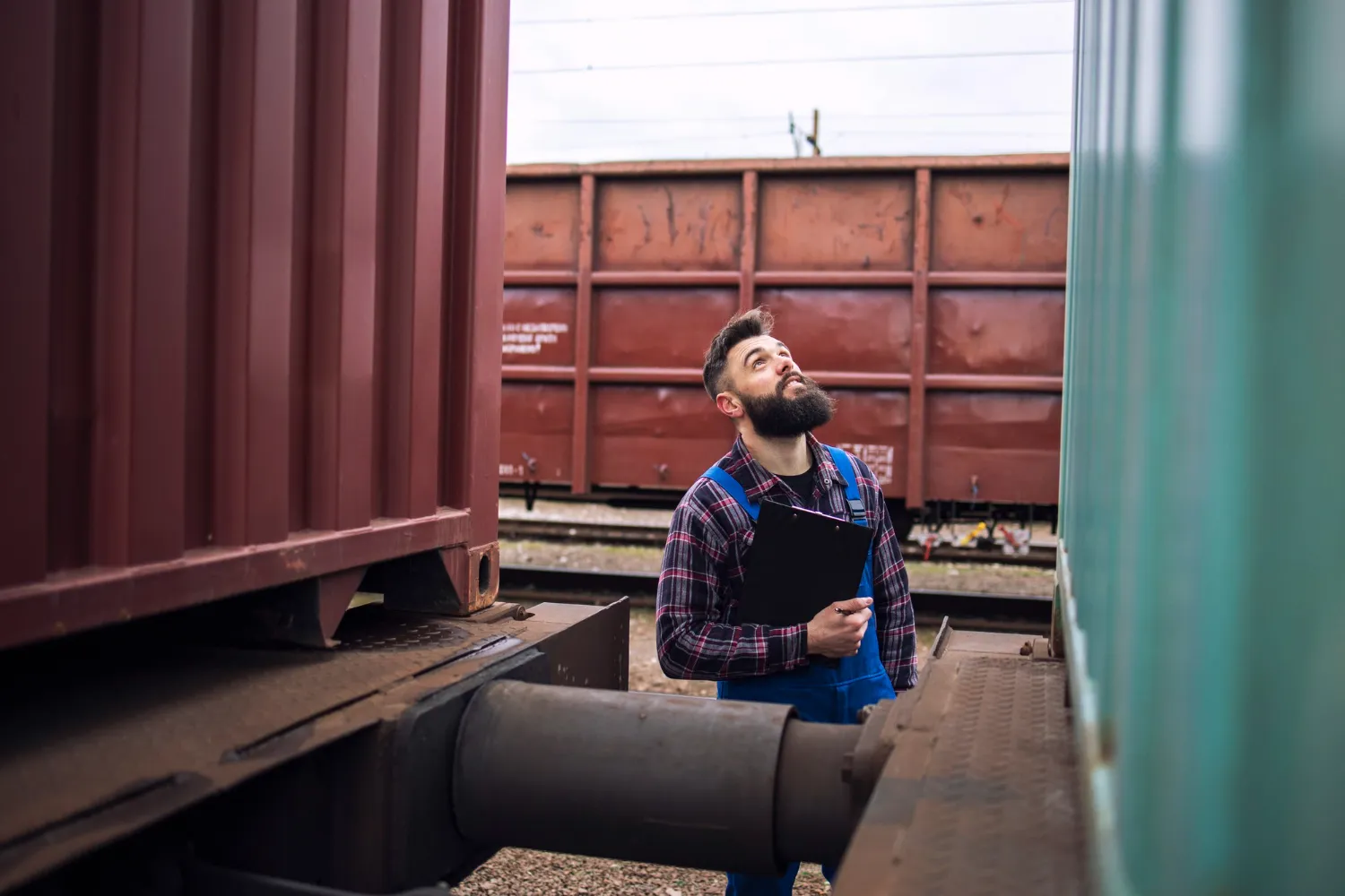 Man inspecting a shipping container structure, representing ArcaVida’s commitment to innovative and sustainable container home design