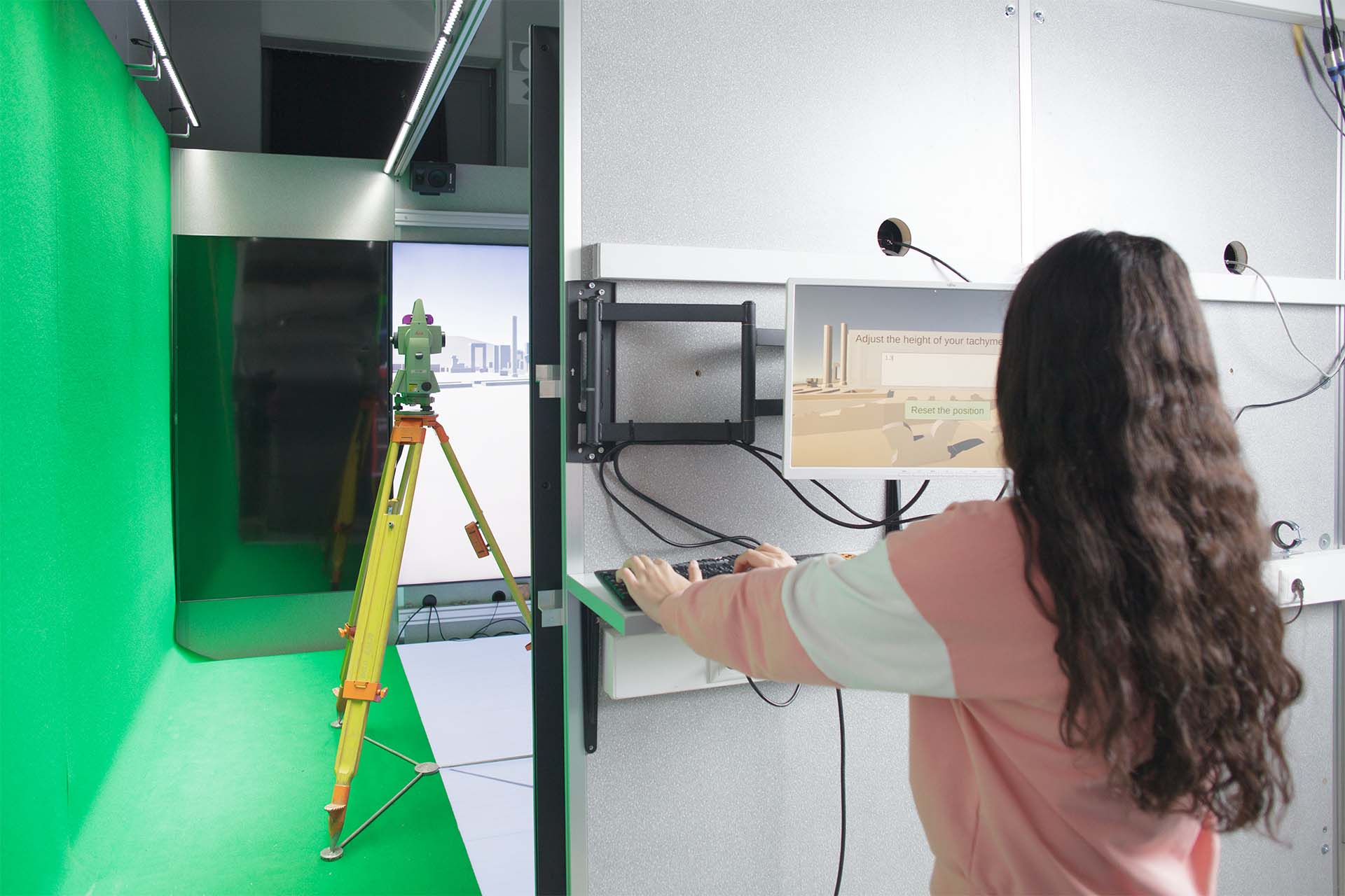 A woman is working on a computer in a technical job