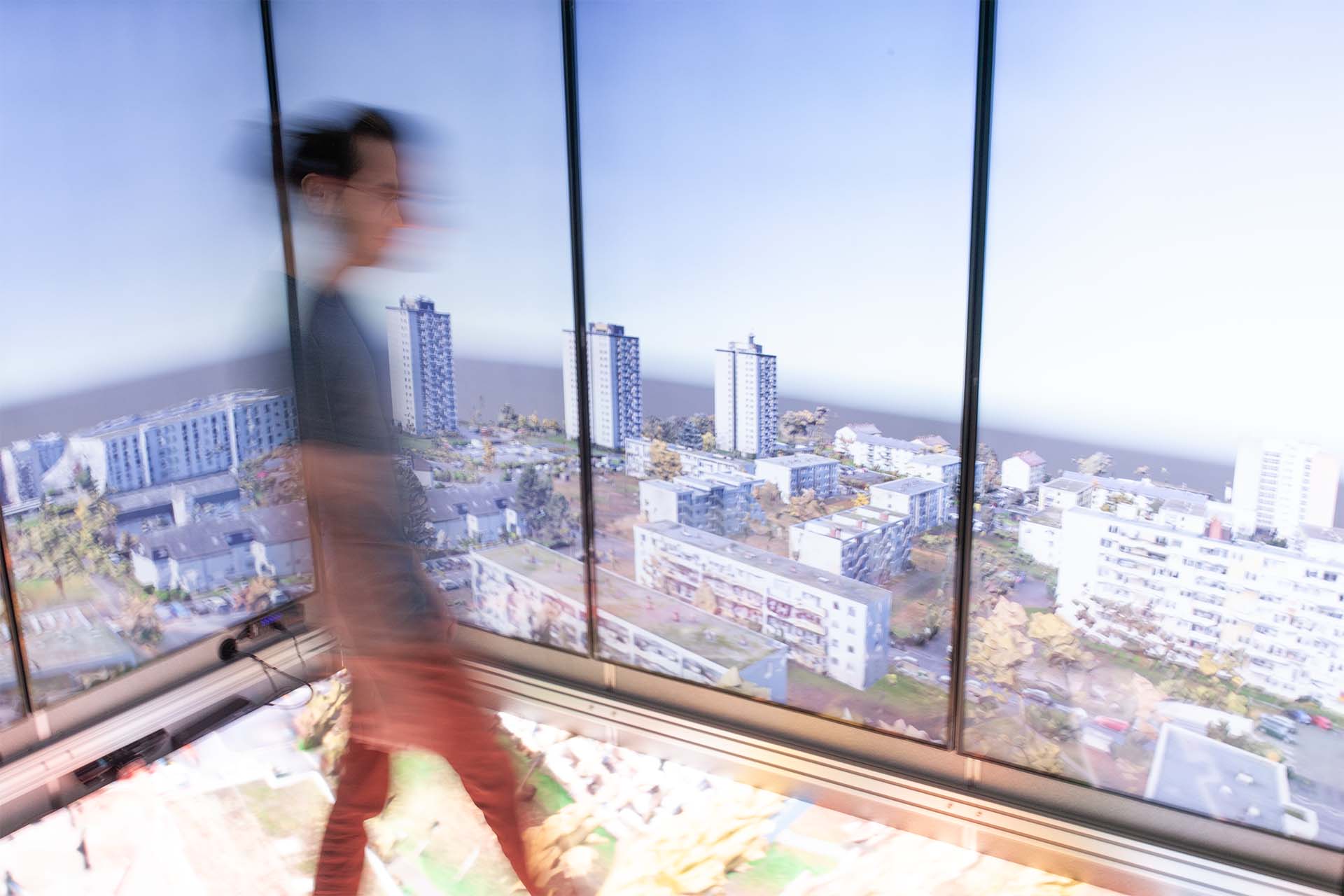 A room made completely of screens with a man walking in it